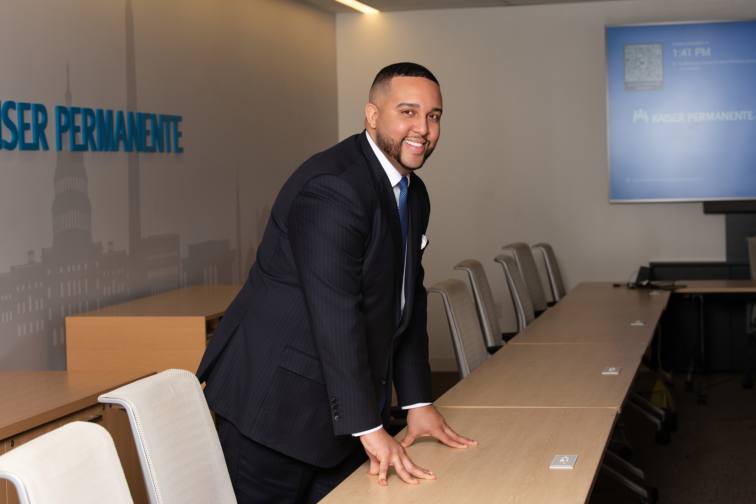 Man in suit smiling at table
