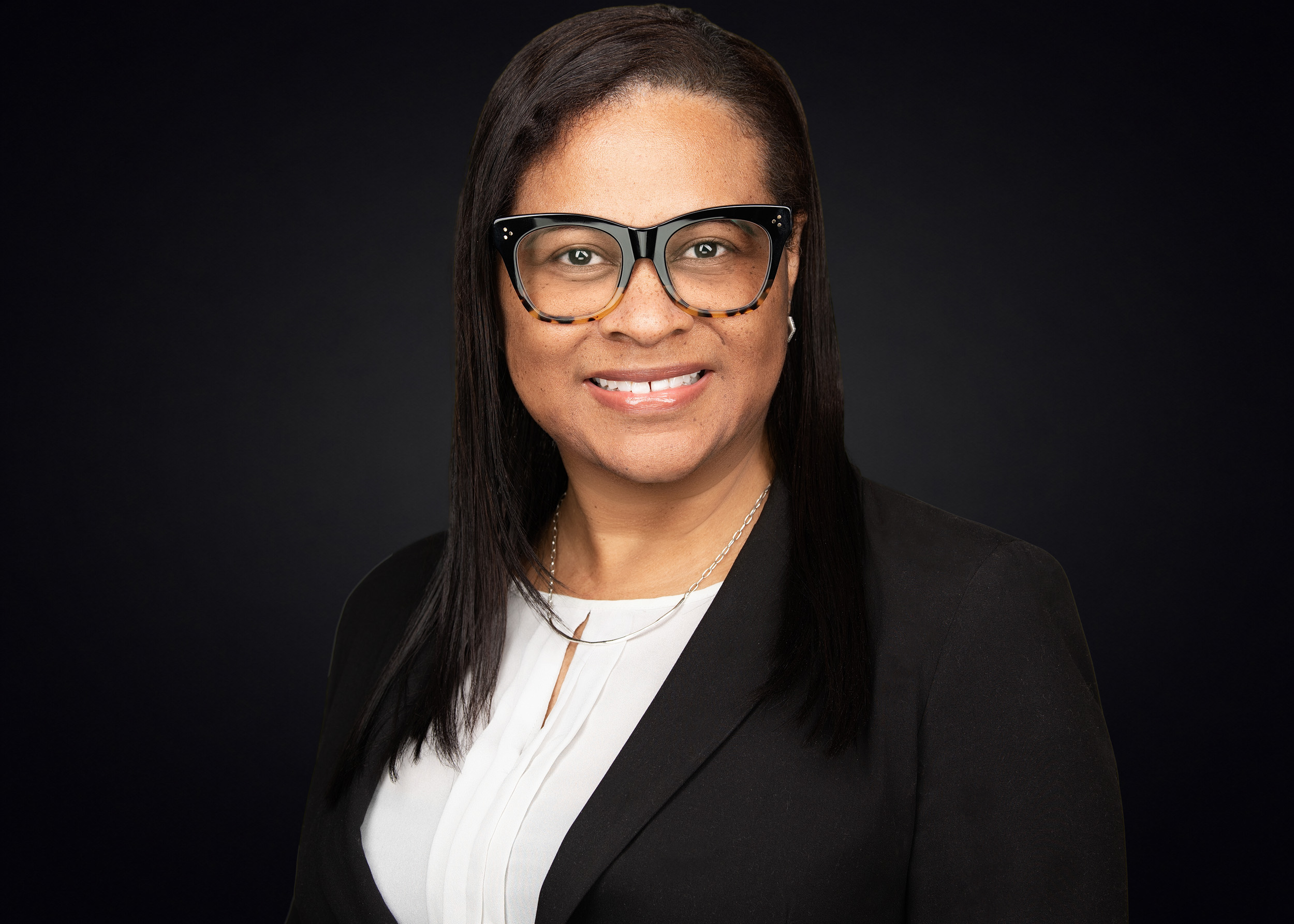 Professional woman with glasses smiling