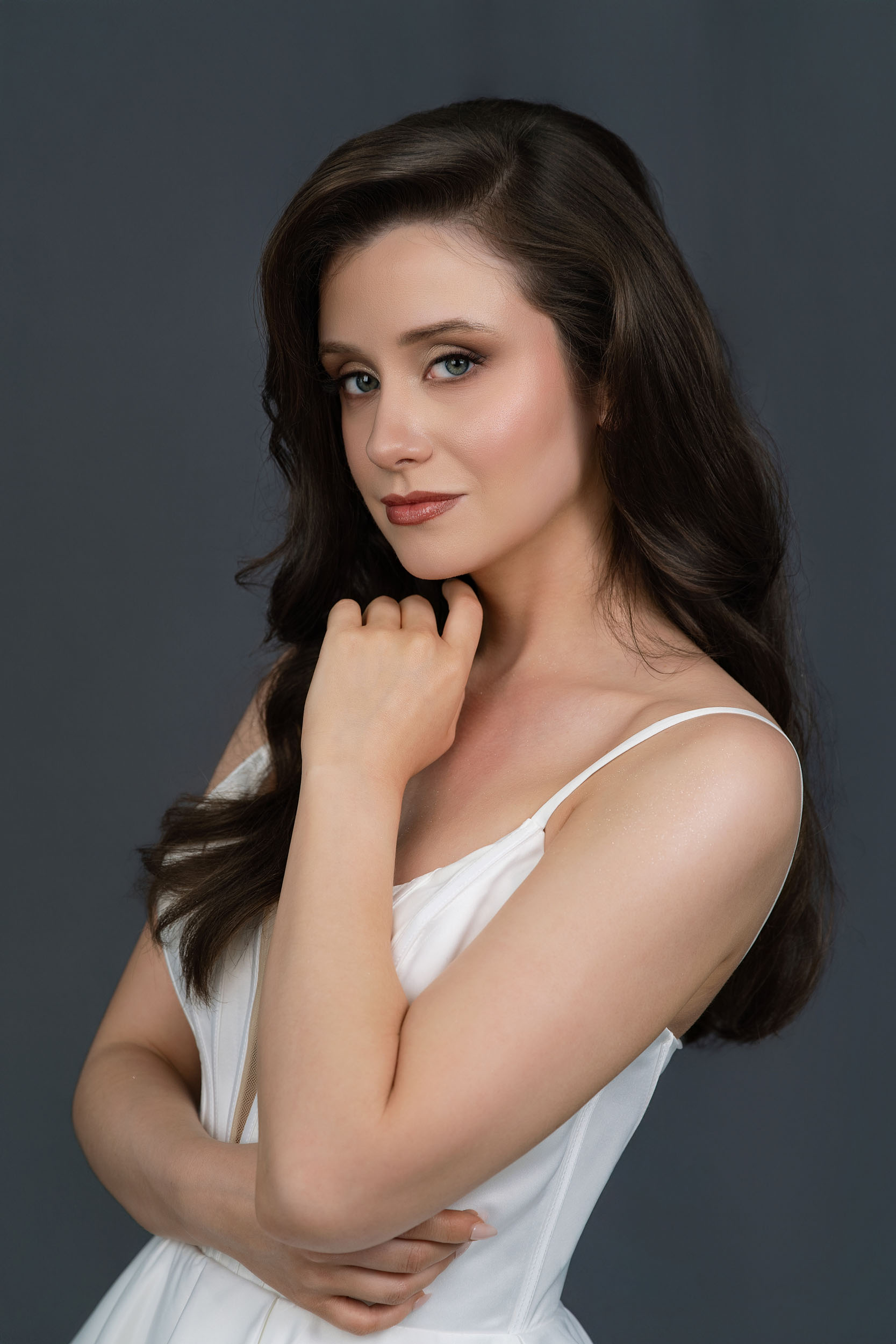 Woman in white dress, elegant pose.